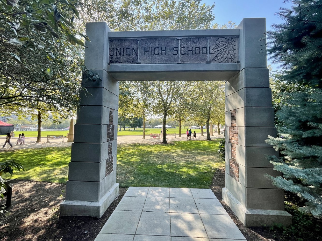 Historic stone archway in a park with text reading Union High School
