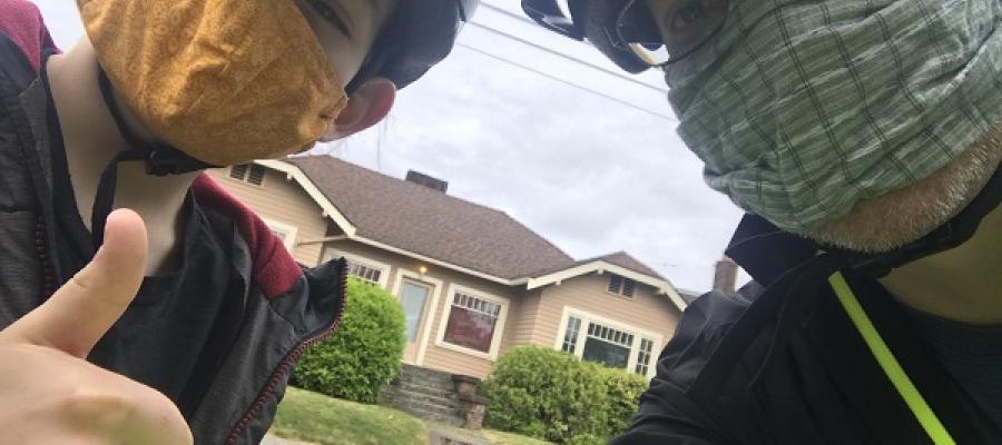 Christopher Shainin and his son wearing masks while out on tandem bikes.